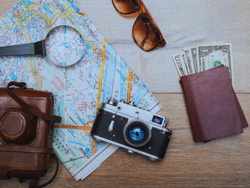 stock photo including a map, vintage camera, and money to signify travel