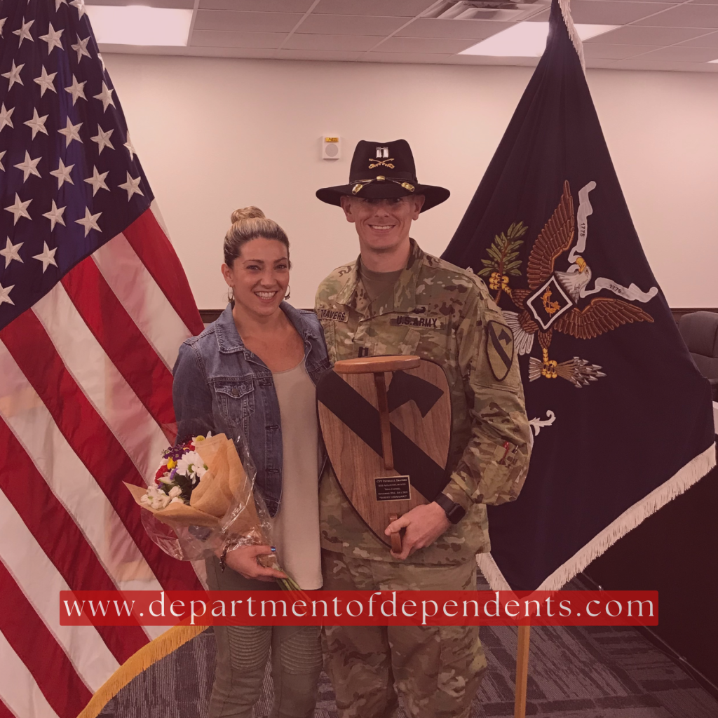 wife and husband pose for a military award photo