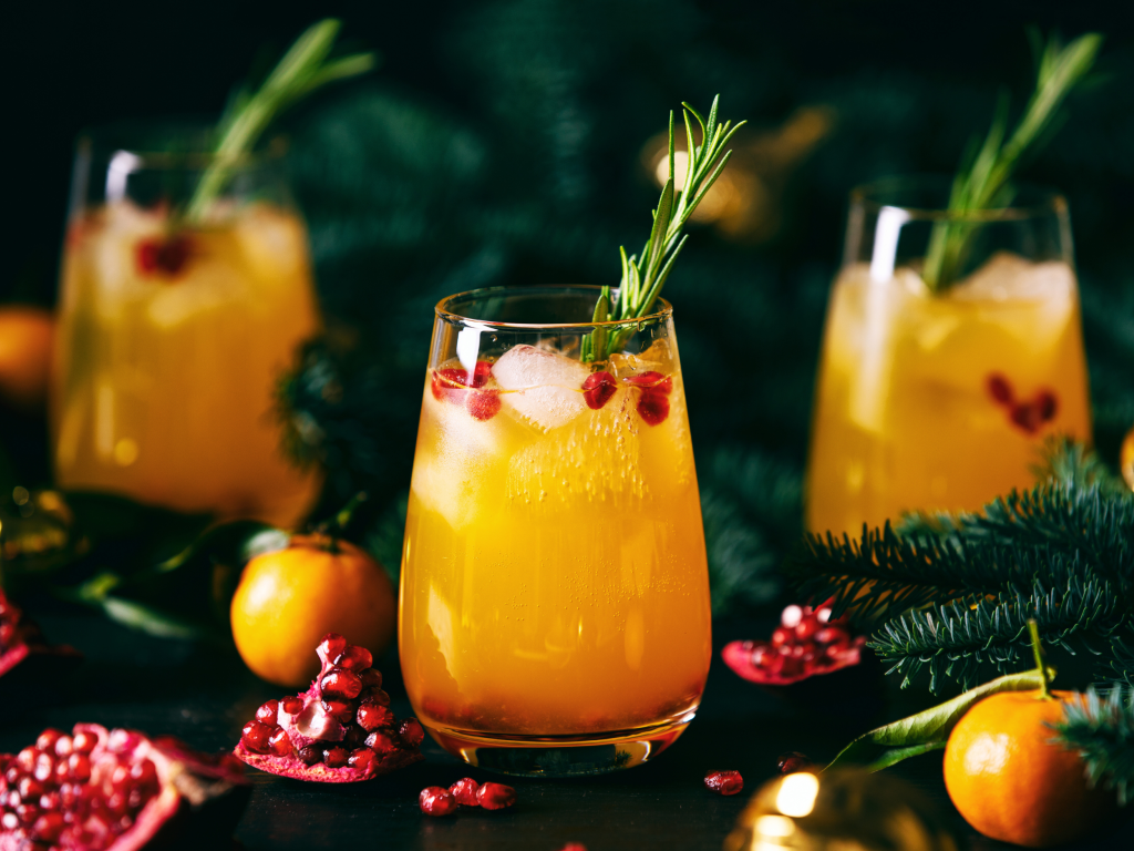 holiday cocktails surrounded by holiday evergreen decor